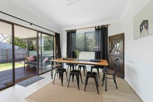 a dining room with a table and chairs at Barker Retreat in Burrill Lake