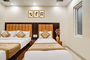 two beds in a hotel room with a window at Hotel Aerotech Near Delhi Airport in New Delhi +21 photos