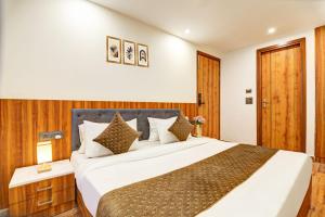 a bedroom with a large bed in a room at Hotel Aerotech Near Delhi Airport in New Delhi