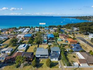 an aerial view of a town with houses and the ocean at Sundance - Collingwood Beach holiday home in Vincentia