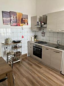 a kitchen with stainless steel appliances and a table at Casa Clem centro Menaggio con possibilità di garage in Menaggio