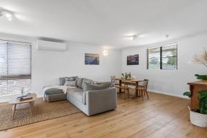 a living room with a couch and a table at Lilly Pilly at Callala Beach in Callala Beach