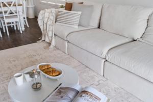 a living room with a white couch and a table at Sanctuary Splash Getaway in Sanctuary Point +29 photos