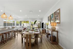 a kitchen and living room with a table and chairs at Mare Mio Callala Beach Jervis Bay in Callala Beach