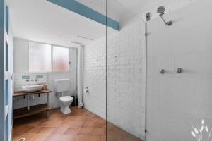 a bathroom with a toilet and a sink and a shower at Kangaroo Sanctuary Studio in Sanctuary Point