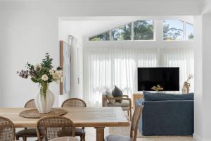 a living room with a table and a blue couch at Husky Salt in Huskisson +29 photos