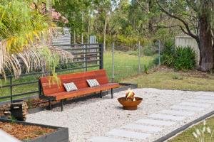 a bench with two pillows and a dog sitting next to it at Kangaroo Sanctuary in Sanctuary Point +28 photos