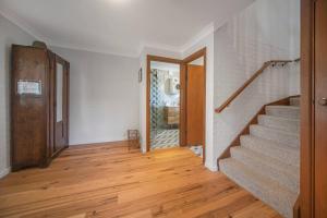 a hallway with stairs and a door and a room at Sea Stroll at Callala Beach in Callala Beach