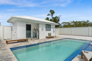 a swimming pool in the backyard of a house at Beachside on Beecroft in Huskisson
