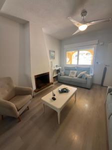 a living room with a couch and a coffee table at Casa Flores in El Campello