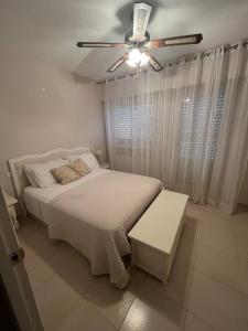 a bedroom with a bed and a ceiling fan at Casa Flores in El Campello