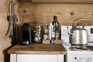 a kitchen counter with a tea kettle and bottles at Traditional Log Cabin At Vierli in Rauland