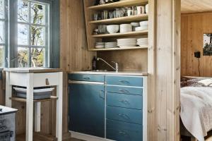 a kitchen with a blue cabinet and a sink at Traditional Log Cabin At Vierli in Rauland +31 photos