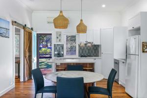 a kitchen with a table and chairs in a room at The Shack - Myola in Myola