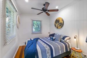 a bedroom with a bed and a ceiling fan at The Shack - Myola in Myola