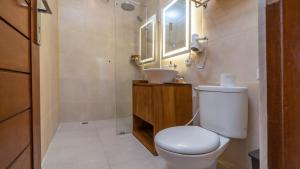 a bathroom with a toilet and a sink and a mirror at Sriwedari 40 Ubud in Ubud +61 photos
