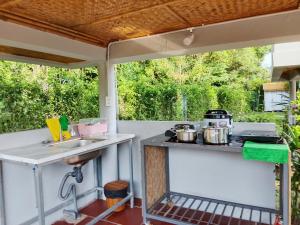 an outdoor kitchen with pots and pans on a patio at Forest Home Phu Quoc is located beside the forest and on a hillside in Phú Quốc