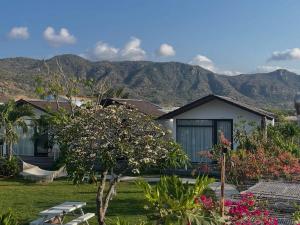 a view of a house with mountains in the background at Phan rang kite center in Ấp Mỹ Hải