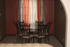 a dining room with a glass table and chairs at Cozy Apartment in Kingston