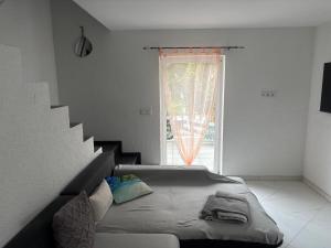 a bedroom with a bed and a staircase in front of a window at Ferienhaus Nine in Oberthal