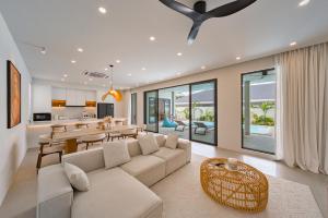 a living room with a couch and a dining room at Valentine Village in Choeng Mon Beach