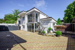 a house with a cat walking in front of it at Vila Romantika in Palanga