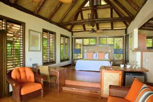 a bedroom with a bed and a table and chairs at Savasi Island Resort in Savusavu +135 photos