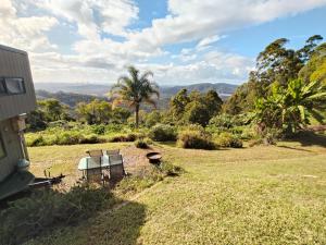 a table and two chairs sitting in a field at Bottletree Gardens - Mini Manson Blue in Gold Coast