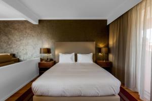 Postel nebo postele na pokoji v ubytování Vilamoura Garden Hotel