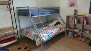 a bedroom with a bunk bed with a bedspread at L'Hibiscus-Joli T3-70m2- Terrasse-Jardin in Entre-Deux