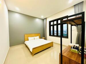 a bedroom with a bed and a loft bed at LaLa Villa Đà Lạt in Da Lat