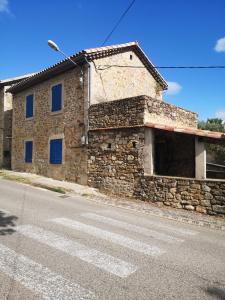 a stone building on the side of a street at Maison proche centre Les Vans in Les Vans