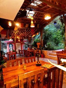 a wooden table and chairs in a restaurant at TATHASTU RETREAT BiR -TRB in Bīr