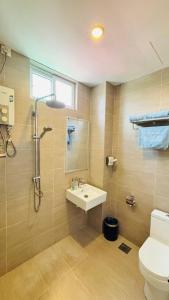 a bathroom with a sink and a shower and a toilet at Seaview Apartment in Kuah +45 photos