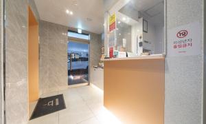 a store lobby with a counter and a sign on the wall at Uiwang Nine Hotel in Uiwang