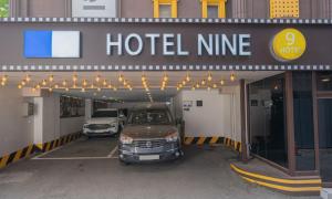 two cars are parked in a parking lot at Uiwang Nine Hotel in Uiwang
