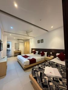 a large bedroom with two beds and a kitchen at The Berry House in Satara +37 photos