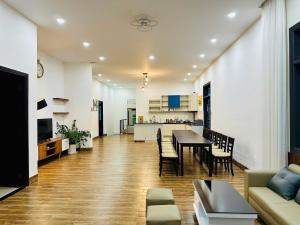 a living room and kitchen with a table and chairs at LaLa Villa Đà Lạt in Da Lat
