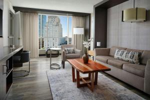 a living room with a couch and a table at Durham Marriott City Center in Durham