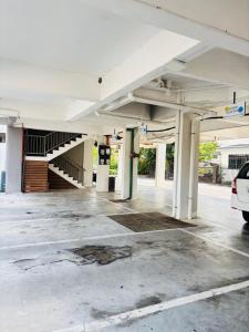 an empty parking lot with a car parked in it at Seaview Apartment in Kuah