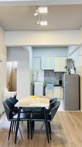 a kitchen with a table and chairs in a room at Seaview Apartment in Kuah