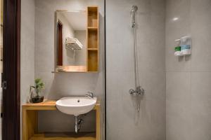a bathroom with a sink and a shower at Casananta Seminyak in Seminyak