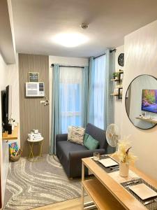 a living room with a couch and a table at H4R1 Luxe Haven in Bacolod