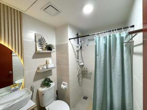 a bathroom with a toilet and a shower at H4R1 Luxe Haven in Bacolod +97 photos
