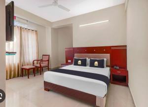 a hotel room with a bed and a chair at Fab Krishna hotal in Panchkula