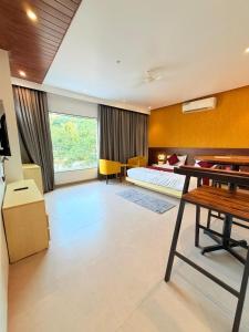 a bedroom with a bed and a desk in a room at The Berry House in Satara