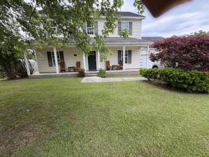 a white house with a lawn in front of it at Marvielous Stay in Jacksonville