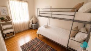 a room with two bunk beds and a rug at Driftwood at Blacksmiths in Blacksmiths