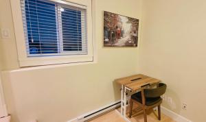 a small table and a window in a room at 2 Bedrooms Guest Suite in Victoria in Victoria