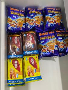 a shelf with several bags of tarantani snacks at De' Haven Stay - 10minutes to Airport Tawau in Tawau